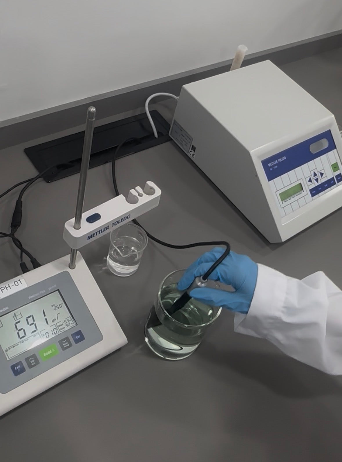 Chemist conducting cosmetic batch liquid testing in the quality control laboratory
